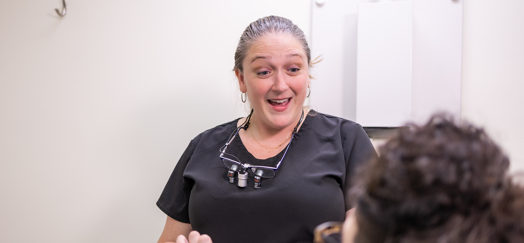 Dental team member talking to a patient about dental implants in Lincoln Park